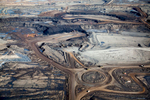 Open Pit Mines, Alberta, Canada 2014(Trucks at tar sands mines carry loads of up 400 tons and cost approximately $5-6 million each. Their tires, seen lining the traffic circle at Syncrude Mildred Lake, have a diameter of 13 feet, weigh more than 15 tons, have a lifespan of 12 to 15 months, and cost about $50,000 each)