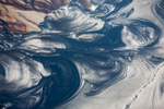 Oil Swirls on Tailing Pond, Alberta, Canada 2014(After mining, tar sands are mixed with hot water to separate the bitumen, or oil, from the sand. This slurry passes through multiple processes of separation before the wastewater is pumped out in to tailling ponds on the mining site. Traces of oil remain in this water and rise to the top of the ponds while sand settles to the bottom)