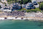 Rip rap is commonly used in attempts to protect homes, like these in Swampscott, Massachusetts, but it inadvertently leads to beach erosion in the long run. Waves hit the stone walls and ricochet off them, stripping away sand in the process.