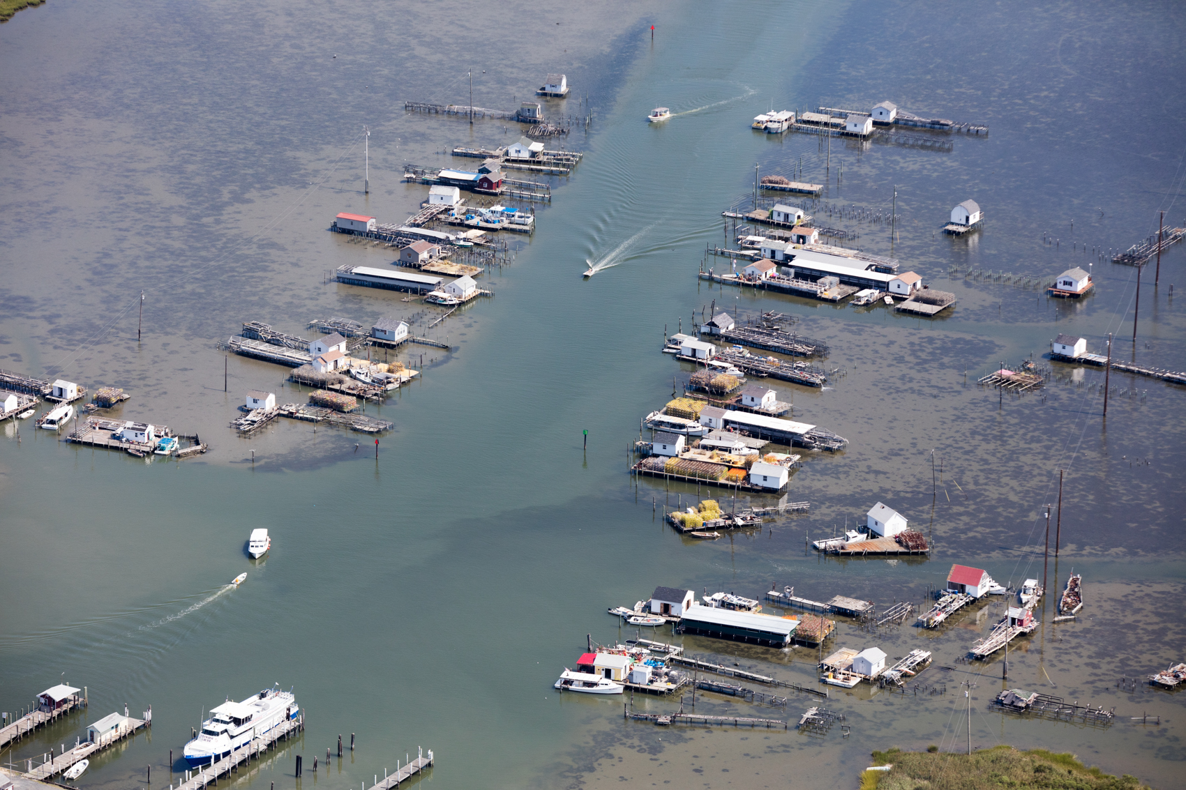 Docks and boat sheds line the canal coming into the town in Tangier, Virginia. The island, located at the mouth of the Chesapeake Bay, is predicted to be uninhabitable in the next 30 years due to a combination of sea level rise and subsidence.