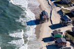 Houses in Nags Head, North Carolina raised on stilts to protect against flooding. Property owners have watched their beaches slip away, and residences that once stood on stable ground are now randomly scattered in the surf zone due to erosion.