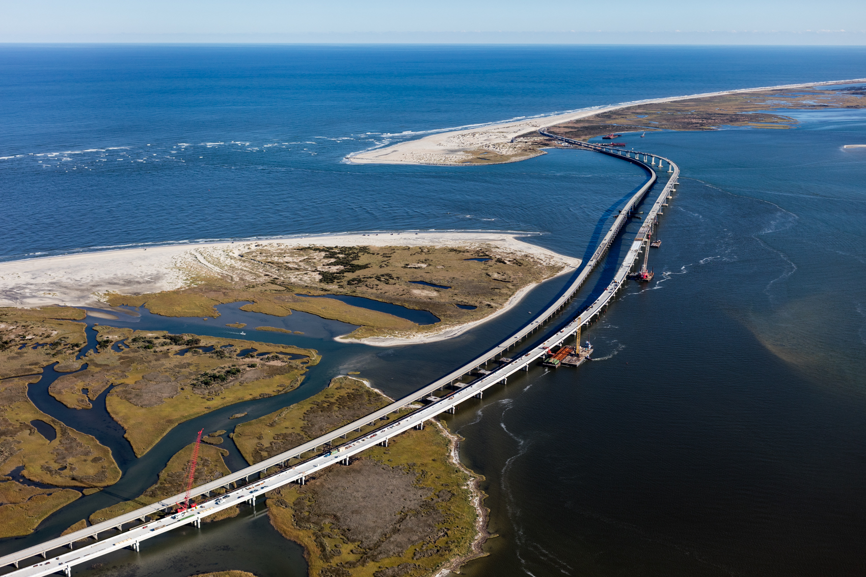 A bridge spans Oregon Inlet in Nags Head, North Carolina. The inlet moves an average of 66 feet per year, having moved over two miles south since 1846.