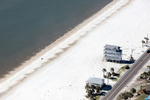 Houses in Port St. Joe, Florida, which lost neighbors to Hurricane Michael in 2018, have been repaired, but now lack natural protection from the barrier dune which was washed away.