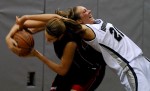 Monmouth's Jennifer Bender (right) bends backwards over St Francis' Janie Killian (left) in an attempt to regain control of the ball during the game at Monmouth University. 