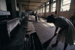 A woman sweeps the floor of a bread factory in Tirane, the capitol of Albania.