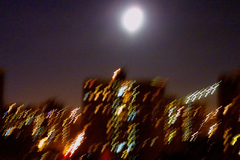 Manhattan's full moon rise brightened the sky, the collective inner glow of the buildings inspired thoughts of lunar myths. A view from the Brooklyn Bridge looking north. 