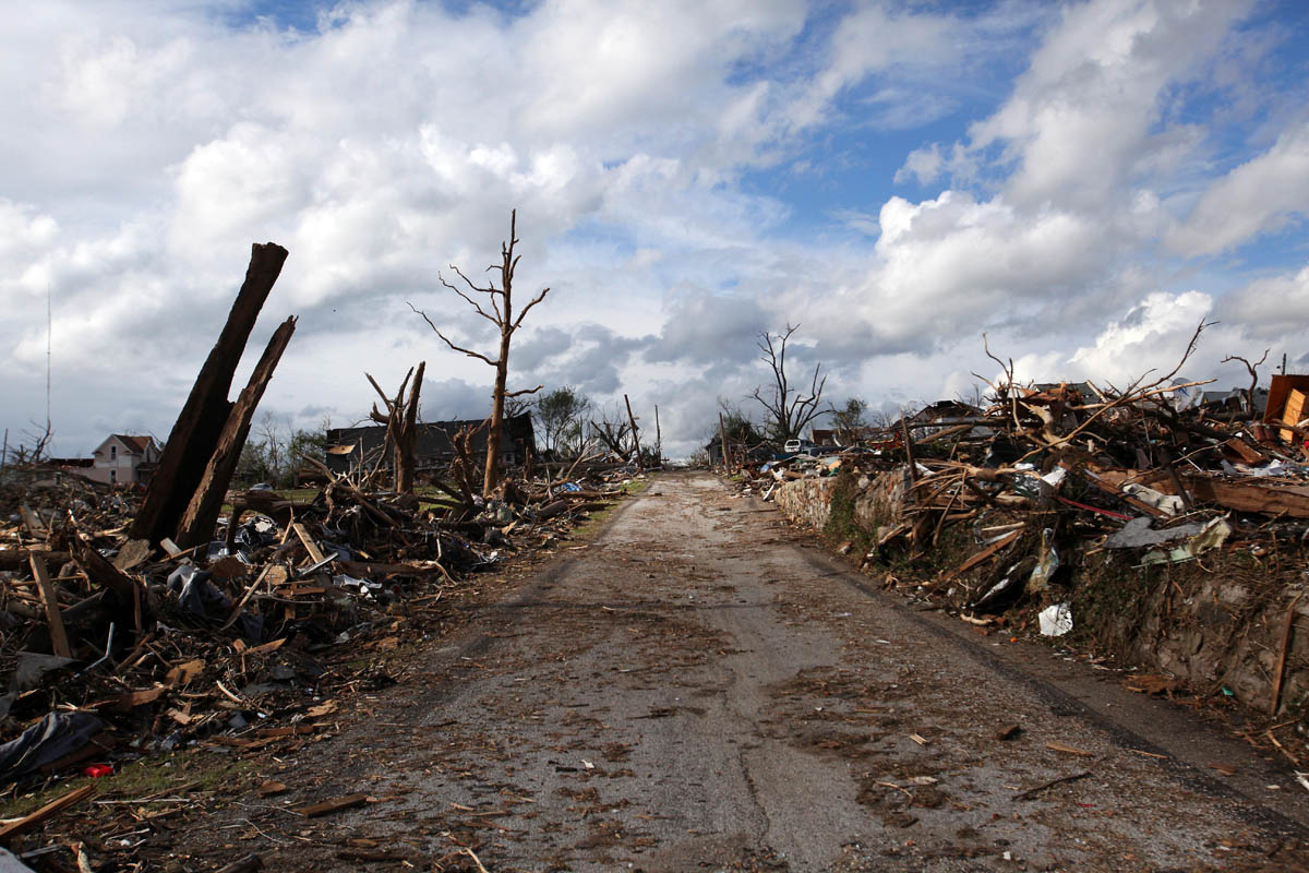 Tornado aftermath in Joplin, MO. A road has been cleared next to Cunniingham Park.