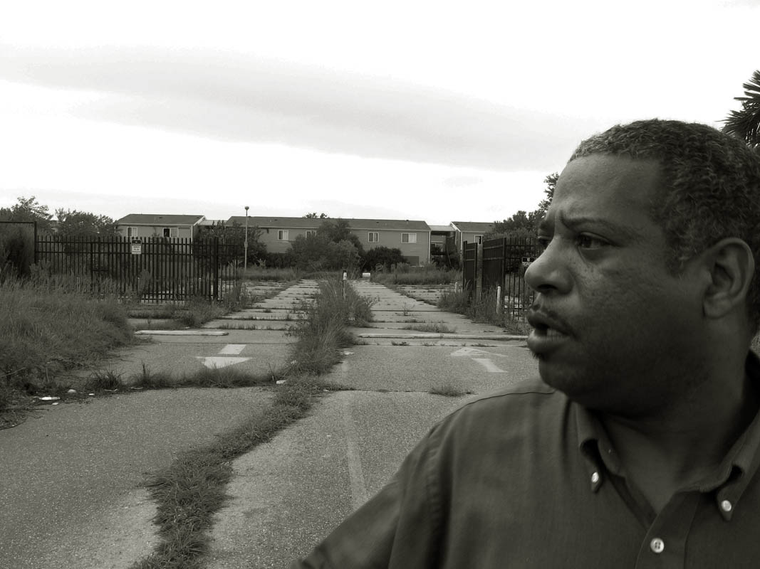 East Shore resident and community leader Aaron Broussard, stands near the deserted Curan Apartment complex that stretches for several blocks along Curan Ave. The blight of absent residents and overgrown properties are his first concern regarding the neighborhood. He used to live in section eight housing and vowed to buy his own home. He did it and now he wants to keep it nice. He wishes the abandoned apartment property would be developed into a shopping center for the east New Orleans neighborhood.