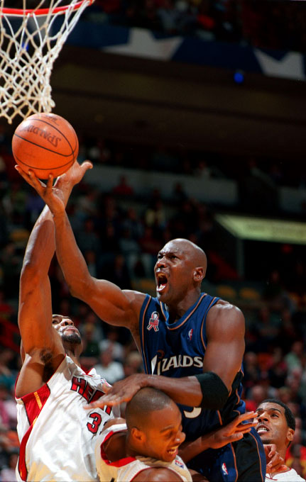 Michael Jordan drives towards the basket in Miami against the Miami Heat on November 30, 2001 after coming out of retirement to play for the Washington Wizards.  Jordan announces that he will donate his salary to victims of the September 11th attacks. 