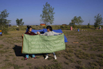 Shrostina Magar, 14, left and Puja Rai, 14, right, unfurl a sleeping bag before placing it in their tent at their campsite in Hooper, Colo. on Sept. 2, 2017. 