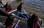 Susmita Adhikari, 16, upper left, and Laxmi Adhikari, 14, center, are all smiles as they canoe for the first time at the Bear Creek Reservoir in Lakewood, Colo. on Oct. 14, 2017. 