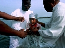 A child rises out of Broad Creek at Hilton Head Island as church elders baptize her. River baptisms are still a common tradition in the African-American church in the lowcountry region along the coast of South Carolina and Georgia.