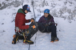 Climbing guide Dillon Diering, 22, left, helps Nirshika Neopany, 14, right, prepare for an ice climb at Camp Alexander at Lake George, Colo. on Feb. 17, 2017. The camp is run by the Boy Scouts of America.