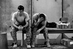 (l-r) Pfc. Christopher Scott, 20, of Dumfries, and Spc. Sam Sivers, 23, of Mt. Sidney, wait for their next assignment while at Camp Adder. As the war winds down, there increasingly is less to do for the troops than before.