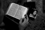 Alvin Boguess, 24, of Covington, reads the bible at Camp Taji in Iraq not long before heading out on his final convoy mission. {quote}I try to read the Bible before every mission,{quote} said Boguess who keeps a picture of his wife, Shannon at the side while he reads. {quote}It (the picture) reminds me of what I've got back home.{quote} 