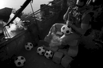 Seaman Chris Welch, 27, pumps up soccer balls which will later be given while the Navy's Riverines are out on patrol in Iraq. The unit routinely gives out soccer balls as part of the {quote}hearts and minds{quote} campaign. As the war winds down, soliders spend more time with such transitional acts. Welch is from Norfolk and is part of the Navy's Riverine Squadron One.