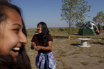 Nirshika Neopany, 14, left and Dechen Drukpa, 14, right, laugh together before making breakfast at their campsite in Hooper, Colo. on Sept. 3, 2017. 