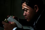 Pauliasi Wolfgramm reads the Bible in his Virginia Beach apartment as morning light sifts through the shades. He reads the bible each morning to start his day. Orginally from Tonga, he is learning to speak and read English. {quote}No matter what the language is, the message is the same,{quote} said Wolfgramm of the Bible.