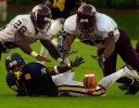 North Carolina Central University football players DeLeon Raynor, (28) left, and Jamar Neely dive for a loose ball during their victory over N.C. A &T during the Aggie-Eagle Classic at Carter-Finley Stadium in Raleigh. NCCU won 33-30. At bottom is Aggies' Douglas Brown.