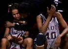 Former NCCU basketball player Fatima Bah consoles Tiona Beatty (20) after their loss in the championship game of the CIAA tournament in Raleigh, N.C. At right is Connie Murdoch (40).