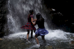 Sostika Chhetri, 14, left, and Dechen Drukpa, 14, run into the Zapata Falls on Sept. 3, 2017. The falls are not far from the Great Sand Dunes National Park and Preserve, where the girls spent much of the day.