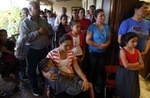 Immigrants crowd into the Our Lady of the Desert Catholic Church, overflowing onto the porch at a standing-room-only Spanish-language Mass on a Thursday night in Mattawa, Washington August 22, 2013.Many immigrants shy away from civic duties in a town that has not always been welcoming. City Hall did not hire interpreters until 2007, when the Department of Justice investigated Mattawa for failing to provide translators in a community where most people only speak Spanish. Instead, the town’s social hub is the Catholic church.