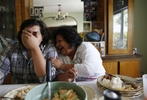 Cynthia de Victoria laughs with her son, Warren, 23, over breakfast at their home in Mattawa, Washington, August 25, 2013. de Victoria was the only Hispanic on the school board in 2009 when she was appointed to fill a vacancy. She urged Latino parents to attend meetings and prodded the white board members to learn how poverty affects learning. When she had to run for the seat in 2011, she lost to a white man.