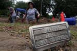 Falfurrias, Texas - University of Indianapolis Graduate Student Erica Christensen, 24, (C) works to exhume a body of an unidentified migrant who apparently died crossing the border and ended up buried anonymously in a pauper's grave in Falfurrias, Texas June 10, 2014. 