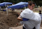 Falfurrias, Texas - Ashley Roy, 30, who works as a crime scene tech for the Waco Police Department in Waco, Texas carries a body of an unidentified migrant who apparently died crossing the border and ended up buried anonymously in a pauper's grave after helping members of the Baylor forensics team to exhume it in Falfurrias, Texas June 10, 2014. 