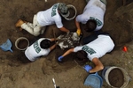 Falfurrias, Texas -  Members of the Baylor forensics team carefully remove the dirt surrounding a body as they work to exhume it in Falfurrias, Texas June 10, 2014. 