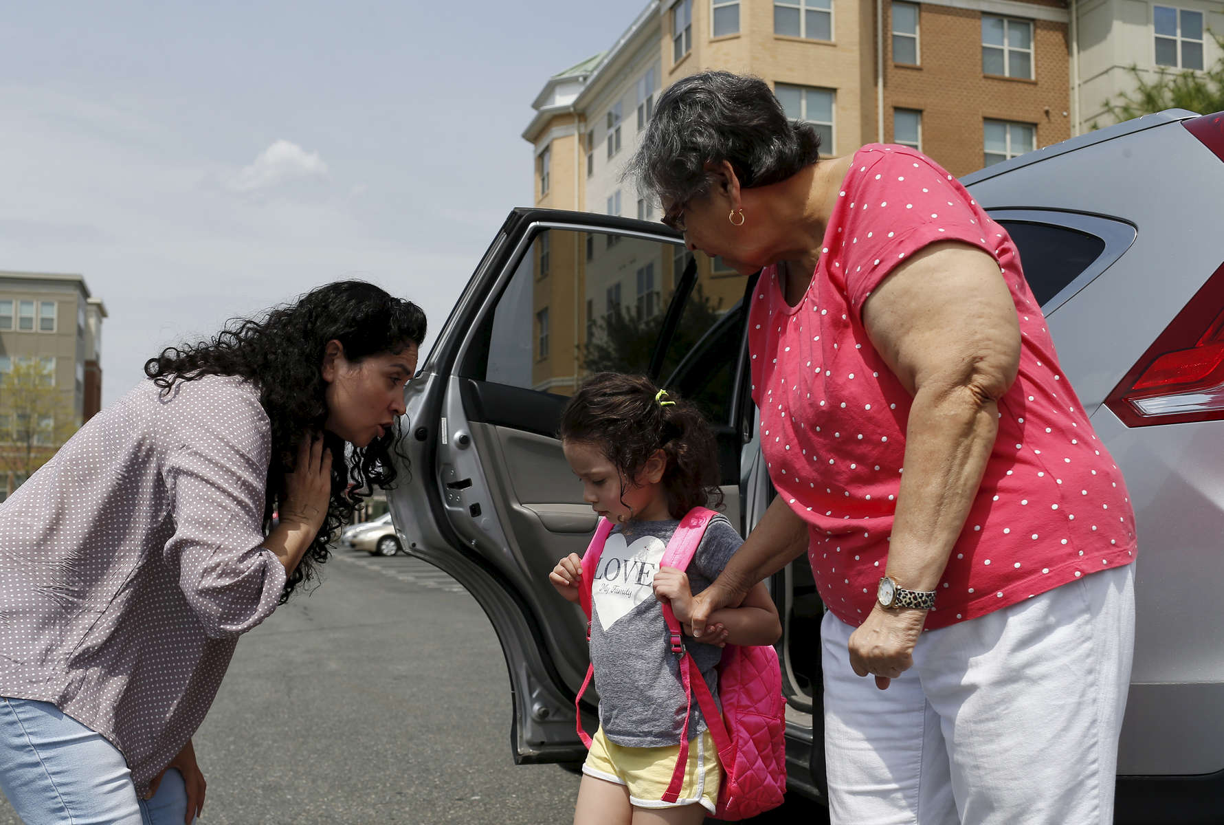 Revere, MA -- 5/3/2018 - Patricia bent down to say goodbye to her daughter, Camila, as she dropped her off with her Godmother's mom, Tete, before a meeting with her immigration lawyer. Fearful that the Trump administration might repeal her Temporary Protected Status Patricia has started to make plans for her daughter, Camila, 4, who is a US citizen. If her TPS was repealed and Patricia were to be unexpectedly picked up and deported, Camila would stay with Tete, one of the few trusted friends that Patricia has who has US citizenship. 