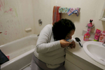 With the bathroom door locked to keep her daughters out, Raquel leans over and snorts heroin inside her apartment. Moments earlier, Estrella had tried to block her mother’s way into the bathroom, and now the girls are crying outside of the door as she gets high.
