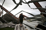 Yabucoa, Puerto Rico -- 9/29/2017 -  In Yabucoa where Hurricane Maria first made landfall, the metal roof and viewing stands from a basketball court across the street were deposited onto Carmen Charriez's home. The family of five, including a nephew, rode out the storm by hiding in a hallway for hours. Nine days later they were still sleeping in plastic lawn furniture in their garage, fearful of their roof collapsing. 