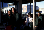Selma, Alabama -- 3/07/2015-- UMass student Marie Cejour, 24, (2nd from L) links arms with Kaya Van Der Meer, 16, (L) as they walk down a main street in Selma, Alabama with the rest of the members of their group March 7, 2015. 