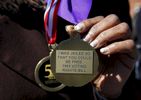 Selma, Alabama -- 3/07/2015-- Linda Hall Gilford of Selma who marched across the Edmund Pettus Bridge at the age of 16 and was beaten as a result shows off the back of a medal in Selma, Alabama March 7, 2015. 