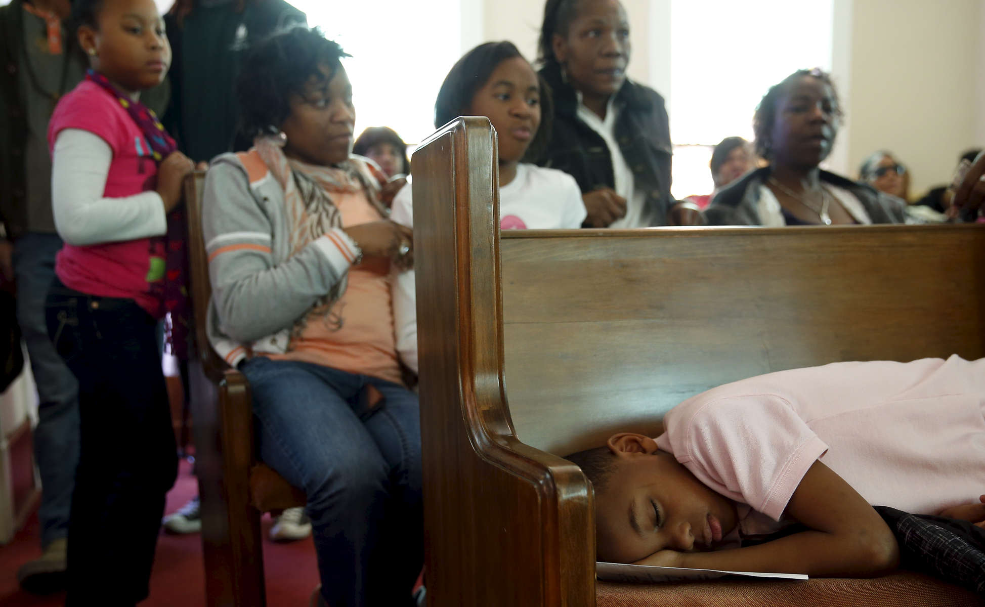 Selma, Alabama -- 3/08/2015-- A boy rests on a pew during services at Tabernacle Baptist Church where former Massachusetts Governor Deval Patrick addressed the faithful in Selma, Alabama March 8, 2015. 