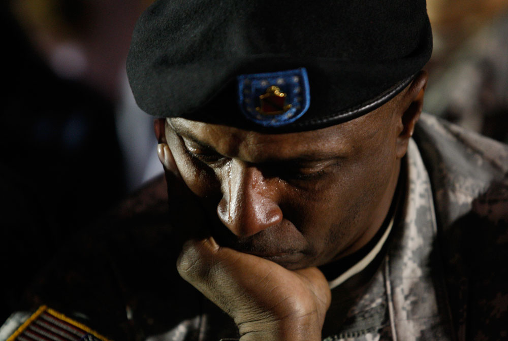 Tears stream down US Army Sgt Major Leroy Walker Jr.'s face during a candle light vigil at Hood Stadium on the Fort Hood Army Post in Fort Hood, Texas November 6, 2009.