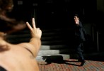 A friend flashes the victory symbol to undocumented worker Mario Rodas, 19, as he makes his way into the Federal Building for his deportation hearing in Boston, Massachusetts June 27, 2006.
