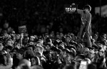 A boy stands above the crowd as democratic presidential candidate Senator Barack Obama (D-IL) speaks at a rally in San Marcos, Texas February 27, 2008.