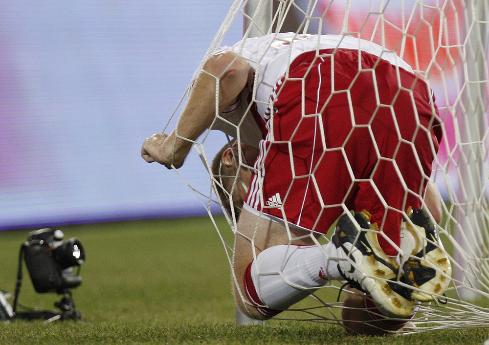Major League Soccer's New York Red Bulls Tim Ream gets caught in the net after trying to defend on Tottenham Hotspur player Gareth Bale's goal during the second half of their game at Red Bull Arena in Harrison, New Jersey July 22, 2010.