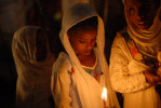 ADDIS ABABA, ETHIOPIA.  Three young girls hold candles during a visit by the Ethiopian patriarch at Holy Trinity Church, where former Emperor Halle Selassie is buried, during the Coptic millennium on September 11, 2007. Ethiopia's Coptic calendar means Ethiopia celebrates the millennium seven year later than the rest of the world on September 11.