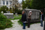 SARAJEVO, BOSNIA AND HERZEGOVINA.  (At right) Andrea Dautovic, 57, a museum adviser and librarian in charge of the exchange of publications, retrieves the key to the ethnographic section of the shuddered Bosnian National Museum from a colleague in the courtyard garden on October 15, 2014.  The museum closed its doors on October 4, 2012 after employees had worked one year without salaries, many of whom continue to work without salaries to this day; the Bosnian National Museum is short the minimum 700,000-800,000 Euro it would need to keep its doors open.