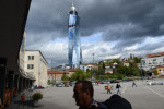 SARAJEVO, BOSNIA AND HERZEGOVINA.  A man carries his bag into the train station, built during the socialist era, and now in the shadow of the Avaz Tower designed by architect Faruk Kapidzic for Bosnian media mogul and former Bosnian nationalist presidential candidate Fahrudin Radoncic on October 17, 2014.