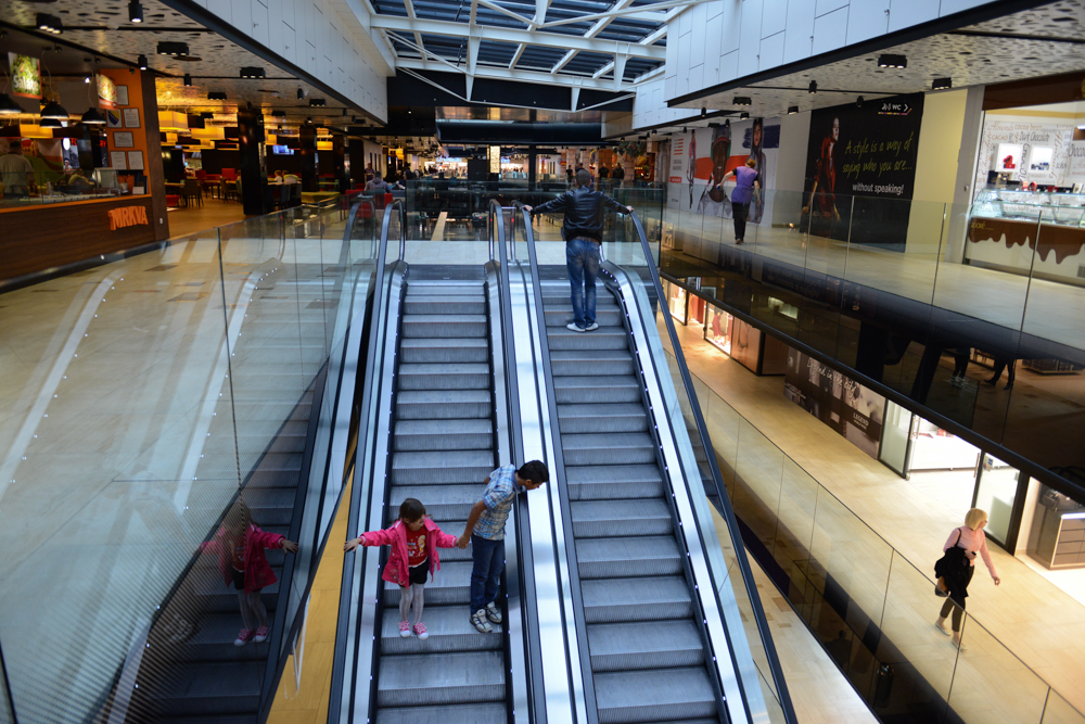 SARAJEVO, BOSNIA AND HERZEGOVINA.  Children ride the escalators for entertainment at the massive Saudi-owned Sarajevo City Center mall designed by architect Sead Golos on October 16, 2014.  Alcohol is not served in any of the mall's restaurants due to the mall's Saudi ownership, to the objections of the architect.