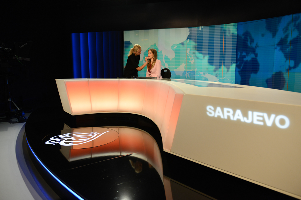 SARAJEVO, BOSNIA AND HERZEGOVINA.  (L-r) Makeup artists Esefa Zornic, 30, touches up news anchor Marina Ridjic, 28, just before going on air on Al Jazeera Balkans in the BBI Center, which was designed by architect Sead Golos, on October 10, 2014.  Qatari-financed Al Jazeera Balkans launched in November 2011 and is an anchor tenant of the BBI Center.