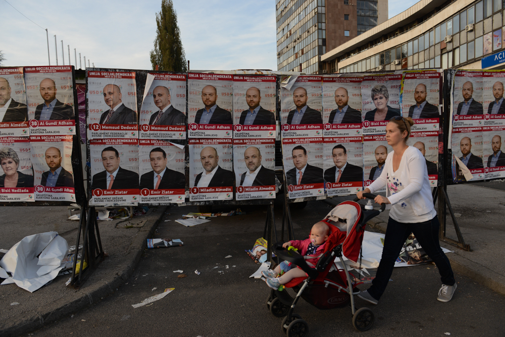 SARAJEVO, BOSNIA AND HERZEGOVINA.  A woman pushes a stroller passed election posters for the Union of Social Democrats ahead of October 12 national elections on October 8, 2014.