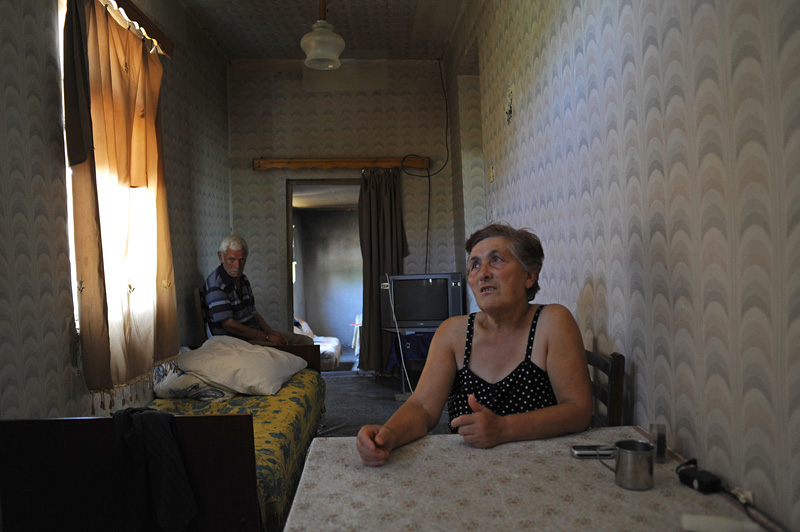 ALAKHI SANGORI, GEORGIA.  Mariam Aptsiauri and her husband Anzori Aptsiauri in their home on August 1, 2010.  While the Aptsiauris have received nothing yet in compensation for having the Baku-Tbilisi-Ceyhan oil pipeline traverse their farmlands, destroying the possibility for continued agricultural production there because of damage to the topsoil and live in poverty, their neighbor Gia Obgaidze is likely the largest recipient of compensation funds in Georgia, which he used to start a chicken farm in addition to remodeling his home; according to an attorney who formerly handled compensation issues with the Young Lawyers Association, Obgaidze likely received 187,000 Georgian lari or approximately $100,000.
