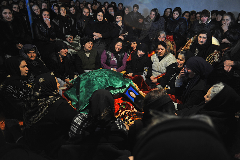 ZAYAM, AZERBAIJAN.  Women during the crying ceremony during the seven day ceremony, part of Azerbaijan's elaborate funeral rituals that include gender segregated commemorations of the deceased three days, seven days and 40 days after their death in Zayam, Shamkir Region, Azerbaijan, approximately four kilometers from the Baku-Tbilisi-Ceyhan (BTC) oil pipeline, on January 3, 2012.  Compensation funds for land traversed by the BTC pipeline paid to the family of the deceased as a result of disruption stemming from the period of the pipeline's construction totaled under $1,000 and went to keeping the deceased healthy and caring for her daughter who suffers from tuberculosis.