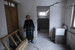 DGVARI, GEORGIA.  Zhenia Gogoladze, 68, outside her house which has been partially destroyed by cracks appearing after a 2007 earthquake in Dgvari, Samstkhe-Javakheti region, Georgia, one village over from Tadzrisi from where the Baku-Tbilisi-Ceyhan (BTC) oil pipeline crosses through the Caucuses mountains, on January 22, 2012.  Due to soft soil, many homes in Dgvari have cracked due to landslides and earthquakes and experts have asserted that the pipeline construction, which included controlled blasts, in the mountain villages near the city of Borjomi may have helped accelerate the pace of seismic activity in the region, although locals believe the pipeline construction are unconnected to recent earthquakes and landslides.