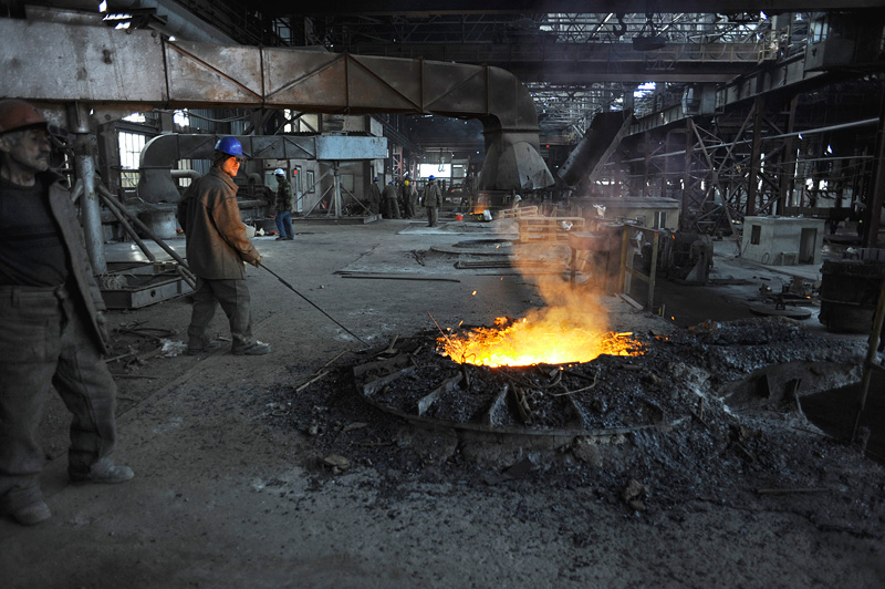 RUSTAVI, GEORGIA.  Workers smelting scrap metal before it is converted to steel at the Rustavi Steel plant in Rustavi, Kvemo Kartli region, Georgia on January 20, 2012.  Built in 1946 at the height of Stalinist power in the Soviet Union and upgraded in recent years, Rustavi Steel employs 1,750 in what was once the greatest industrial center of Soviet Georgia; today several heavy industry factories remain in the city which is traversed by the Baku-Tbilisi-Ceyhan oil pipeline.